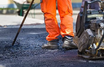 worker providing asphalt repair service