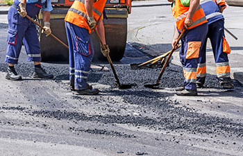 team of workers during asphalt patching repair