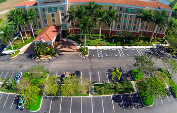 well-maintained parking lot in front of a hotel