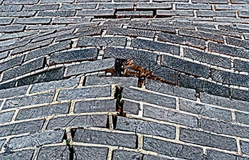 Paving from wooden square bloated and damaged