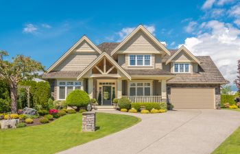 front of big house with driveway and garage