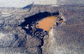 pothole filled with water on asphalt