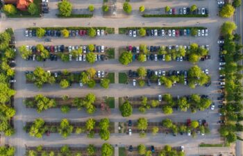 top view of a parking lot with cars in it