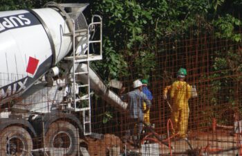 construction crew pouring concrete for paving