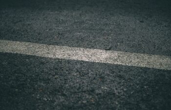 black asphalt pavement with a white striped line