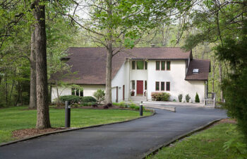 white house with an asphalt driveway