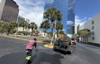 TreadCoat sealcoat going down on the K.C. Wright lot with the downtown Fort Lauderdale skyline