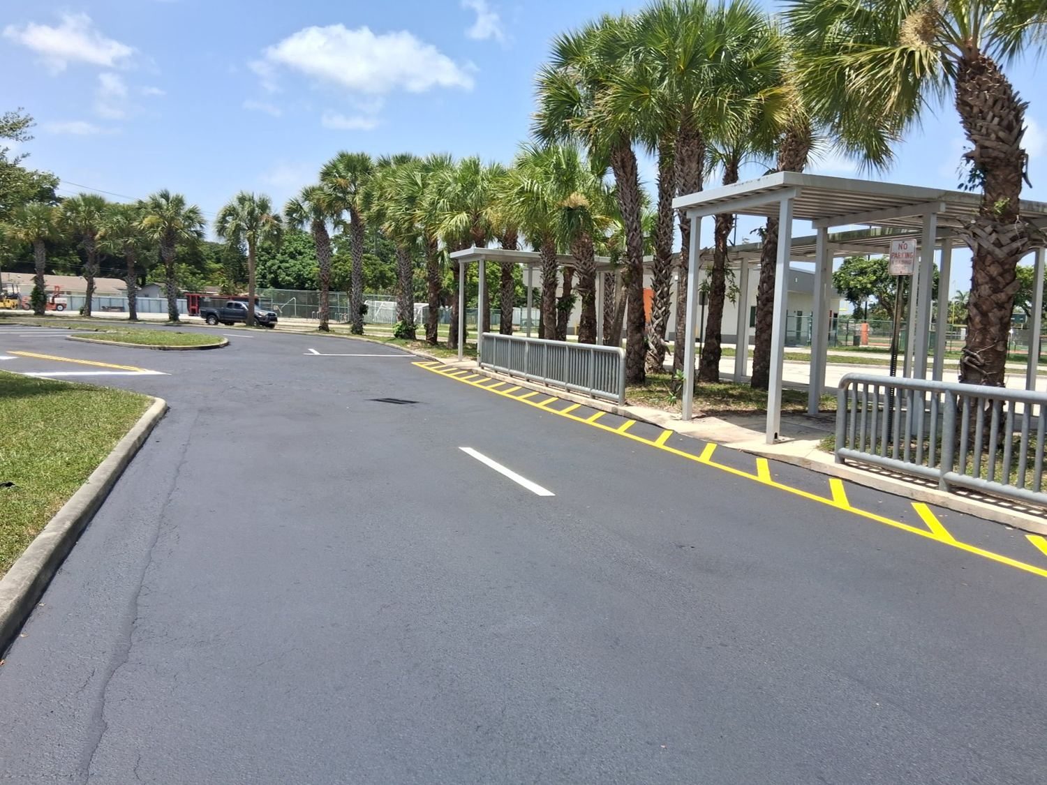 The donated front lot — sealed, striped, ready for game day.