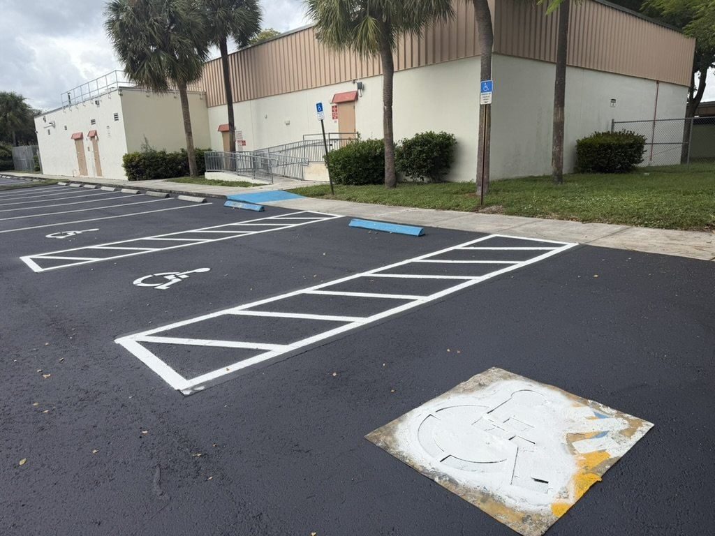 After — ADA stalls rebuilt with hatched aisles, new wheel stops and fresh stencils.