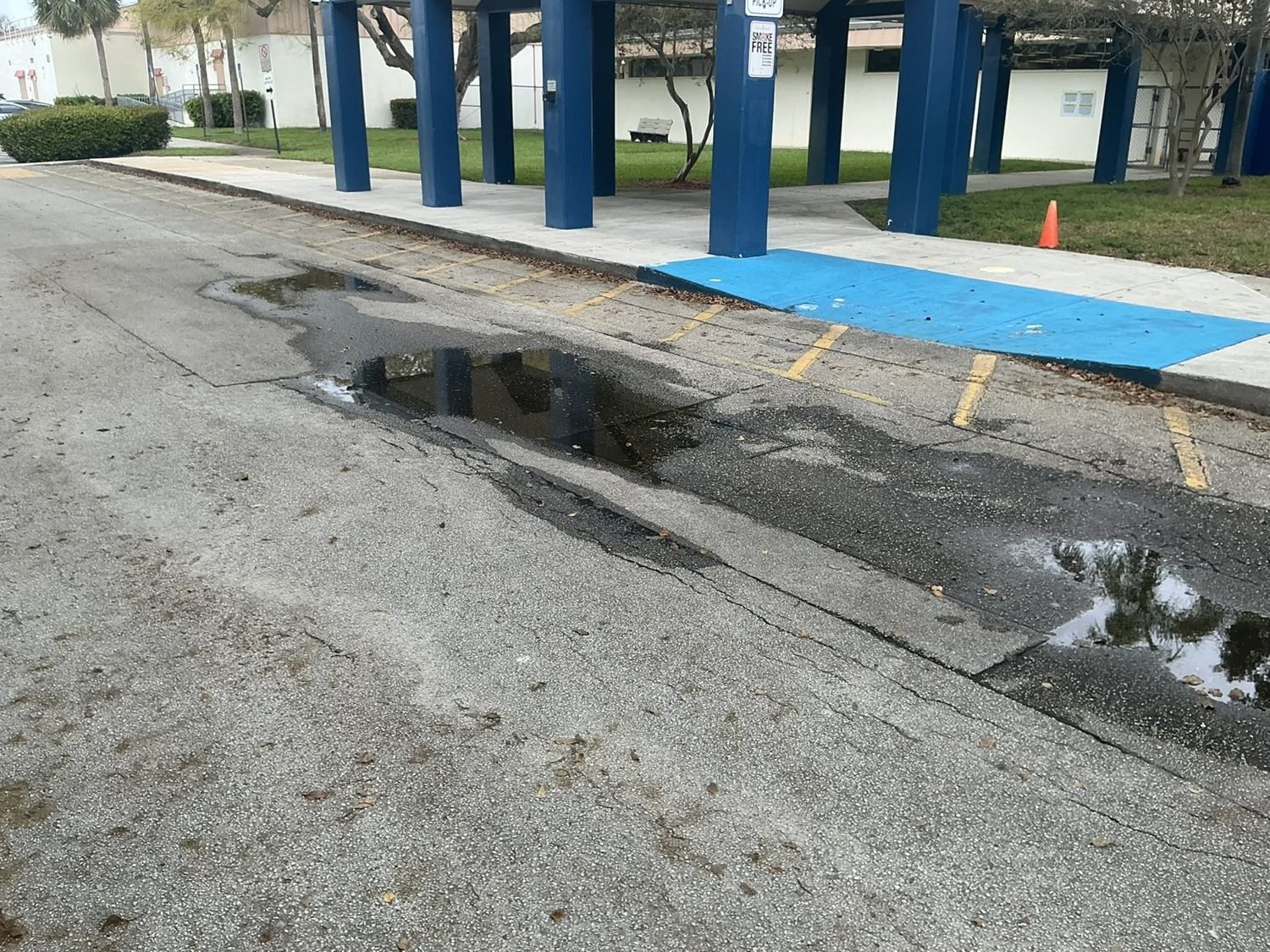 Before — ponding at the drop-off canopy.
